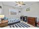 Adorable bedroom with bright artwork, light wood floors, and plenty of room to play and grow at 10095 Oakhurst Rd, Seminole, FL 33776