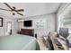 This bedroom features a ceiling fan, tv, and a connected bathroom for extra convenience at 10095 Oakhurst Rd, Seminole, FL 33776
