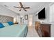 Spacious bedroom with modern lighting, a comfortable bed, and ample closet space at 10095 Oakhurst Rd, Seminole, FL 33776