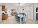 Open dining area and kitchen with stainless steel appliances, granite countertops, and a dining table for six at 10095 Oakhurst Rd, Seminole, FL 33776