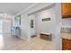 Hallway featuring tile floors, neutral paint and views to the living room and kitchen, offering seamless transition at 10095 Oakhurst Rd, Seminole, FL 33776