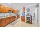 Bright kitchen featuring granite countertops, stainless steel appliances, and custom wood cabinetry at 10095 Oakhurst Rd, Seminole, FL 33776
