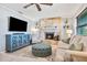 Bright living room featuring a stone fireplace, comfortable seating, and a large flat screen TV for entertaining at 10095 Oakhurst Rd, Seminole, FL 33776