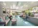 Spacious and relaxing sunroom with wicker furniture and great outdoor views at 10095 Oakhurst Rd, Seminole, FL 33776