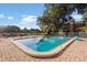 Inviting community pool surrounded by lush landscaping, lounge chairs, and a well-maintained deck at 10423 Carrollbrook Cir # 203, Tampa, FL 33618