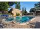 Beautiful community pool with clear blue water and well-manicured landscaping around the brick patio at 10423 Carrollbrook Cir # 203, Tampa, FL 33618