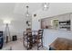 Cozy dining area with modern lighting and decor, adjacent to the updated kitchen at 10423 Carrollbrook Cir # 203, Tampa, FL 33618