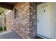 Exterior of a brick apartment building with a white door and the unit number 203 at 10423 Carrollbrook Cir # 203, Tampa, FL 33618