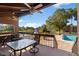 Spacious outdoor deck with a table and chairs, overlooking the pool and lake view at 10423 Carrollbrook Cir # 203, Tampa, FL 33618