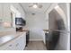 Bright kitchen featuring white cabinets, stainless steel appliances, and light gray flooring at 10423 Carrollbrook Cir # 203, Tampa, FL 33618