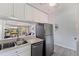 Kitchen area with a view into the living room, featuring stainless steel appliances and modern finishes at 10423 Carrollbrook Cir # 203, Tampa, FL 33618