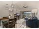 Inviting living room with vaulted ceilings, modern decor, and sliding glass doors to a patio at 10423 Carrollbrook Cir # 203, Tampa, FL 33618