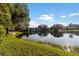 Scenic view of the pond reflecting the sky and surrounding trees, next to the apartment building at 10423 Carrollbrook Cir # 203, Tampa, FL 33618