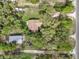 Aerial view of the property showing the house, outbuilding, and proximity to the road at 10614 Hudson Ave, Hudson, FL 34669