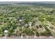 Aerial view shows the property surrounded by lush greenery, highlighting its private and wooded location at 10614 Hudson Ave, Hudson, FL 34669