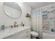 Well-lit bathroom features marble countertops, gold hardware, and modern shower at 10614 Hudson Ave, Hudson, FL 34669