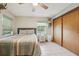 Bedroom with neutral colors, tiled flooring, a large closet, and views of the outdoors at 10614 Hudson Ave, Hudson, FL 34669
