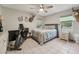 Spacious bedroom featuring exercise equipment and deer mounts, with tiled flooring and light-filled windows at 10614 Hudson Ave, Hudson, FL 34669