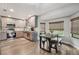 Modern dining area with a stylish table, ample natural light, and seamless kitchen access at 10614 Hudson Ave, Hudson, FL 34669