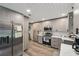 Well-lit kitchen with stainless steel appliances, light wood cabinets, and modern white backsplash at 10614 Hudson Ave, Hudson, FL 34669