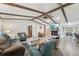 Spacious living room featuring wood beams, a fireplace, and an open floor plan at 10614 Hudson Ave, Hudson, FL 34669