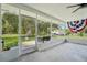 Screened patio overlooking a spacious backyard with a view of a large lawn at 10614 Hudson Ave, Hudson, FL 34669