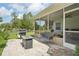 Screened patio with wicker furniture, grill, and brick pavers at 10614 Hudson Ave, Hudson, FL 34669