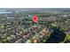 Drone image of a desirable neighborhood situated on a picturesque lake with well-maintained homes at 10751 Tavistock Dr, Tampa, FL 33626