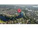 Aerial photo shows a waterfront community featuring homes nestled along a serene lake surrounded by lush greenery at 10751 Tavistock Dr, Tampa, FL 33626