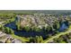 Community aerial view of a residential neighborhood nestled around a scenic lake with mature trees at 10751 Tavistock Dr, Tampa, FL 33626