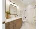 Updated bathroom features a quartz vanity, framed mirror, and shower over tub with subway tile at 10751 Tavistock Dr, Tampa, FL 33626