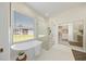 Bright bathroom features a soaking tub and a glass enclosed shower with modern fixtures at 10751 Tavistock Dr, Tampa, FL 33626