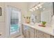 Bathroom featuring a single vanity and a door to the backyard pool at 10751 Tavistock Dr, Tampa, FL 33626