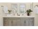 Bathroom features a gray double vanity with a white countertop, framed mirrors, and modern fixtures at 10751 Tavistock Dr, Tampa, FL 33626