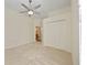 Large bedroom featuring neutral walls, ceiling fan, new carpet, and access to en suite bathroom at 10751 Tavistock Dr, Tampa, FL 33626