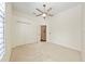 Well-lit bedroom with closet, ceiling fan, and neutral carpet at 10751 Tavistock Dr, Tampa, FL 33626