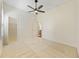 Bright bedroom featuring carpeted floors, a ceiling fan, and a walk-in closet at 10751 Tavistock Dr, Tampa, FL 33626