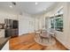 Sunlit breakfast nook features stainless steel refrigerator and backyard pool views at 10751 Tavistock Dr, Tampa, FL 33626