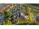 Aerial view of the clubhouse with outdoor seating, parking, and mature trees, offering a welcoming community space at 10751 Tavistock Dr, Tampa, FL 33626