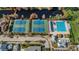 Aerial view showcasing community pool, tennis courts and recreation areas by lake at 10751 Tavistock Dr, Tampa, FL 33626