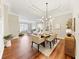 Dining room featuring hardwood floors, neutral decor, and a modern chandelier at 10751 Tavistock Dr, Tampa, FL 33626