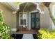 Inviting front porch area with double doors, adorned with seasonal wreaths, and decorative plants at 10751 Tavistock Dr, Tampa, FL 33626
