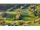 Scenic aerial shot of the well-maintained golf course, featuring verdant fairways, pristine greens, and natural water hazards at 10751 Tavistock Dr, Tampa, FL 33626