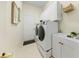 Spacious laundry room featuring modern washer and dryer, storage cabinets and sink at 10751 Tavistock Dr, Tampa, FL 33626