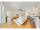 Spacious living room featuring hardwood floors, a ceiling fan, and bright lighting at 10751 Tavistock Dr, Tampa, FL 33626