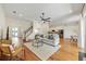 Bright living room with hardwood floors, ceiling fan, and comfortable seating arrangement at 10751 Tavistock Dr, Tampa, FL 33626