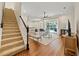 Inviting living room with hardwood floors, a staircase, and views of the backyard pool at 10751 Tavistock Dr, Tampa, FL 33626
