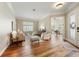 Bright living room featuring hardwood floors, neutral tones, ample seating, and an adjacent office space at 10751 Tavistock Dr, Tampa, FL 33626