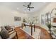 Bright home office with hardwood floors, neutral paint, bay windows, and a ceiling fan at 10751 Tavistock Dr, Tampa, FL 33626