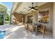 Spacious patio with dining area, seating, ceiling fans, and access to the screened pool at 10751 Tavistock Dr, Tampa, FL 33626